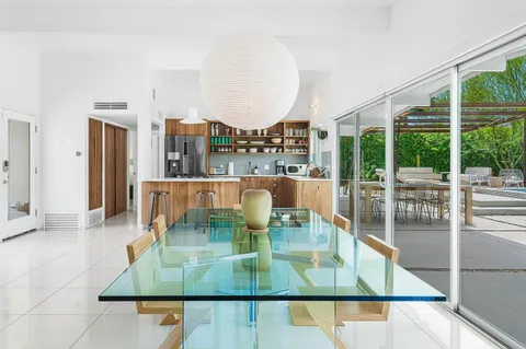 a living room with furniture a large window and a table