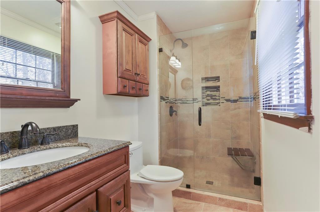1132 Lafayette Drive Southwest Mableton, GA 30126 - Photo 17 of 35 a bathroom with a granite countertop sink toilet and shower
