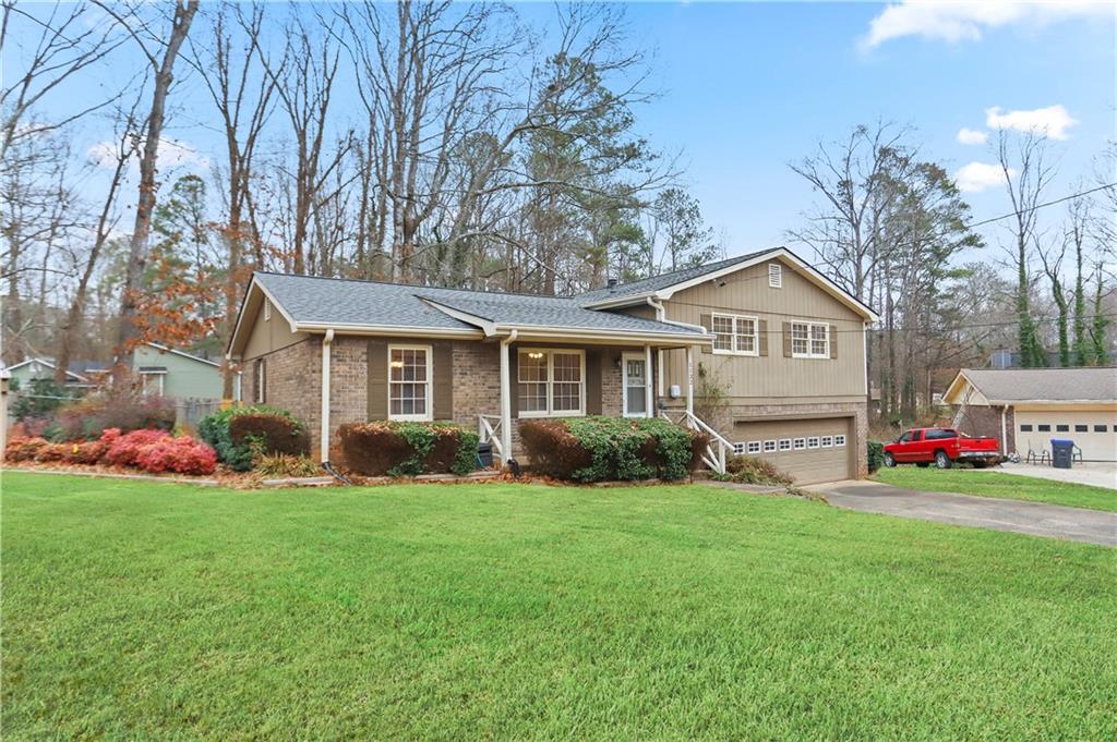 1132 Lafayette Drive Southwest Mableton, GA 30126 - Photo 2 of 35 a front view of a house with a yard and garage
