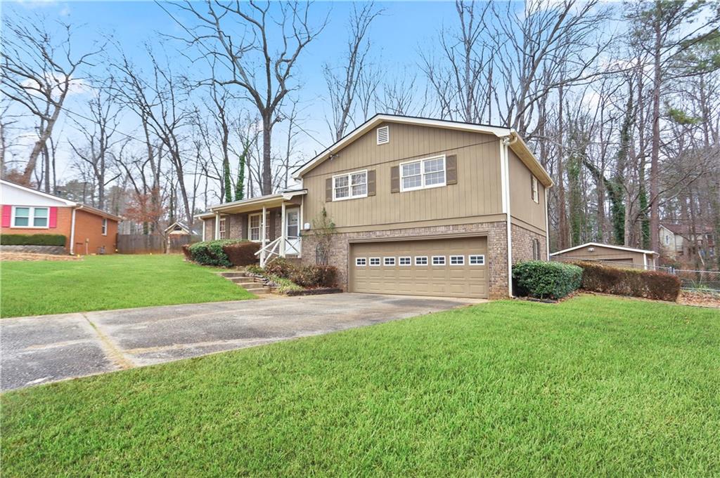 1132 Lafayette Drive Southwest Mableton, GA 30126 - Photo 3 of 35 a front view of a house with a yard and garage