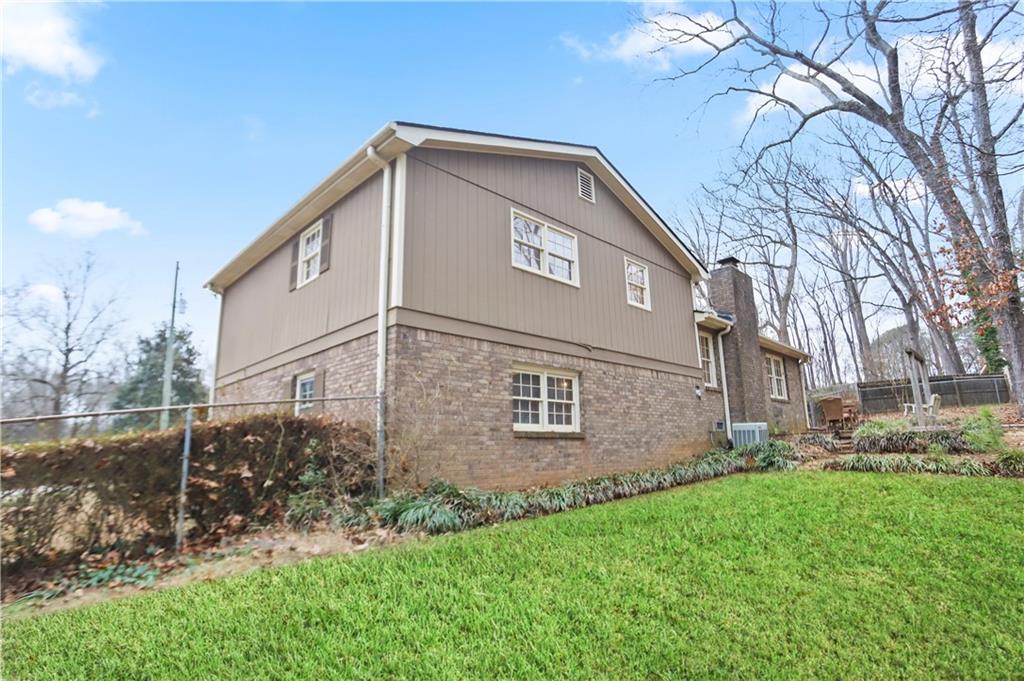 1132 Lafayette Drive Southwest Mableton, GA 30126 - Photo 33 of 35 a front view of a house with garden