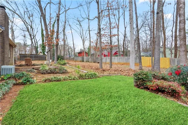 a white house that has a tree in front of it