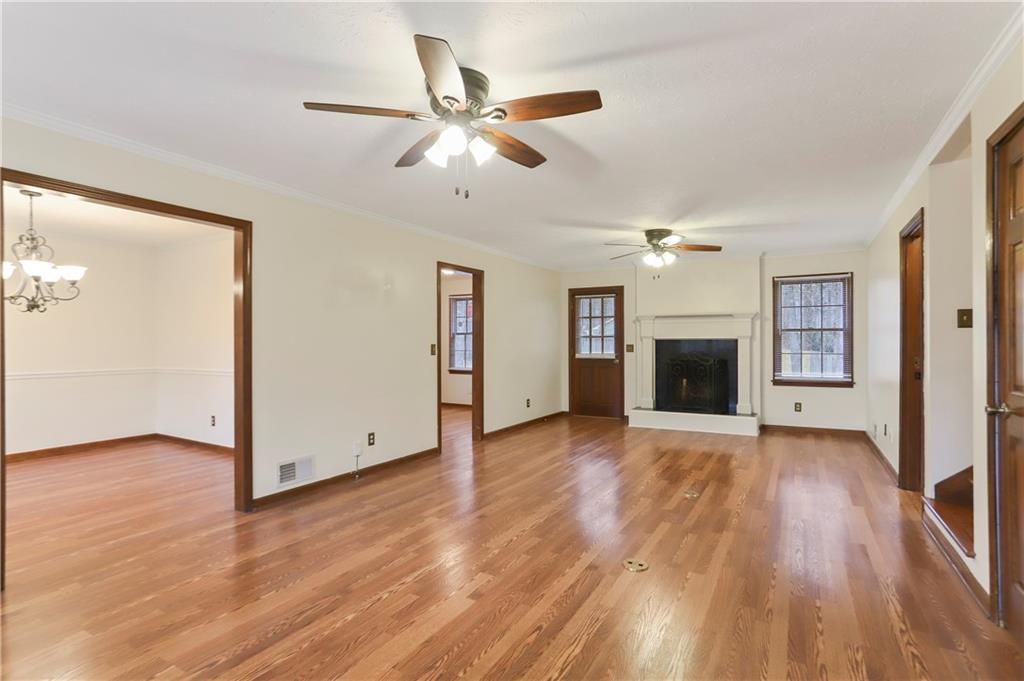 1132 Lafayette Drive Southwest Mableton, GA 30126 - Photo 4 of 35 a view of empty room with wooden floor and fireplace