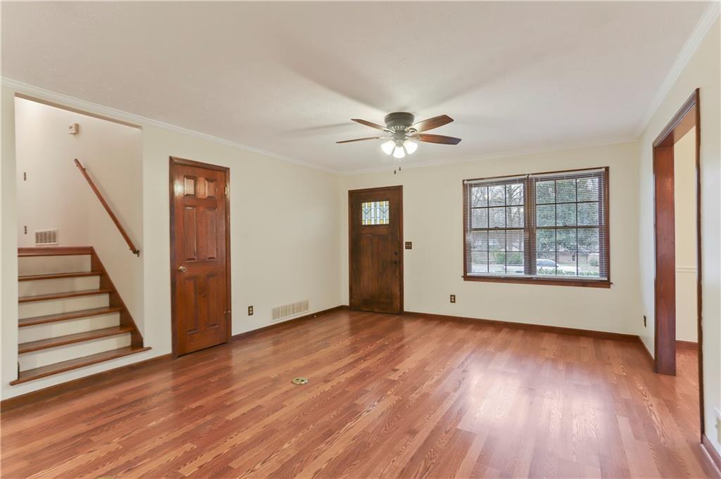 1132 Lafayette Drive Southwest Mableton, GA 30126 - Photo 6 of 35 a view of an empty room with wooden floor and a window
