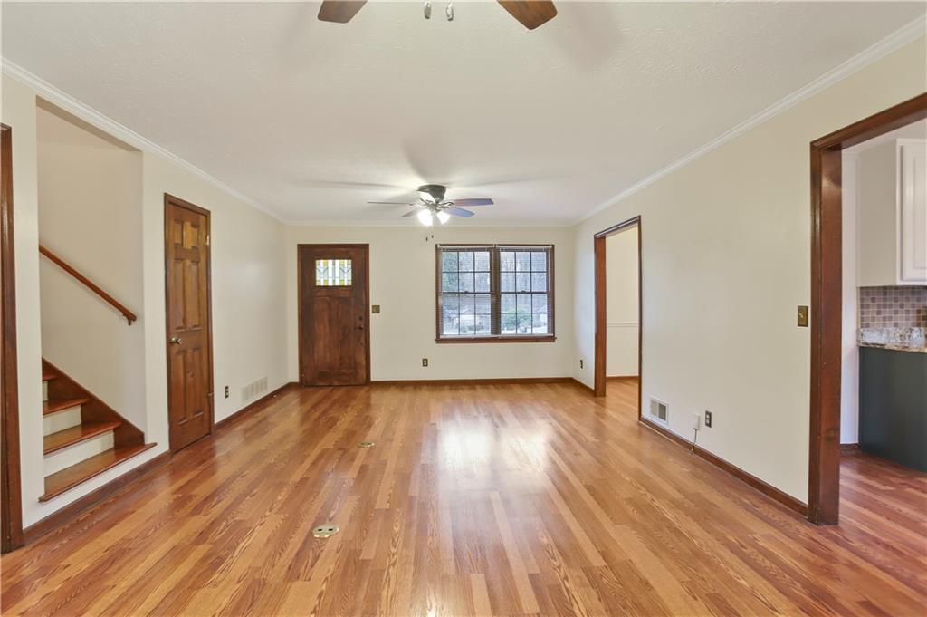 1132 Lafayette Drive Southwest Mableton, GA 30126 - Photo 8 of 35 a view of an empty room with wooden floor and a window