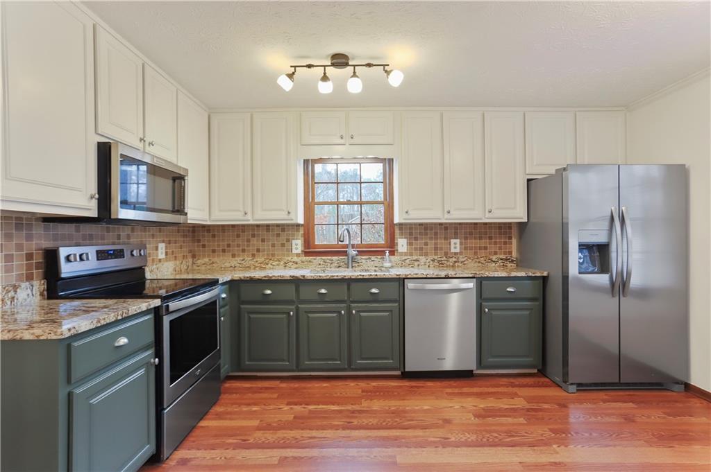 1132 Lafayette Drive Southwest Mableton, GA 30126 - Photo 9 of 35 a kitchen with stainless steel appliances granite countertop a refrigerator and a stove top oven