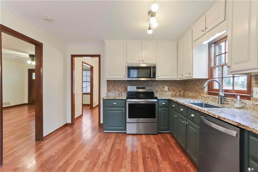 1132 Lafayette Drive Southwest Mableton, GA 30126 - Photo 10 of 35 a kitchen with stainless steel appliances granite countertop a stove a sink and a refrigerator