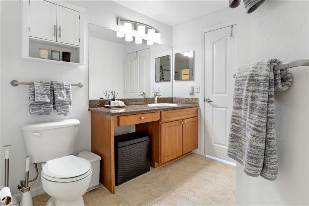 12980 Positano Circle, Unit 202 Naples, FL 34105 - Photo 16 of 27 a bathroom with a sink toilet and shower