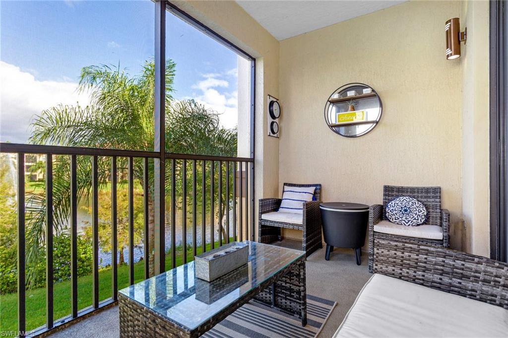 12980 Positano Circle, Unit 202 Naples, FL 34105 - Photo 24 of 27 a living room with furniture