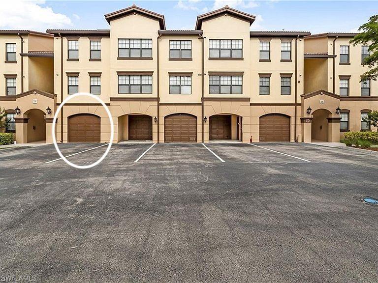 12980 Positano Circle, Unit 202 Naples, FL 34105 - Photo 25 of 27 a view of a blue building with many windows