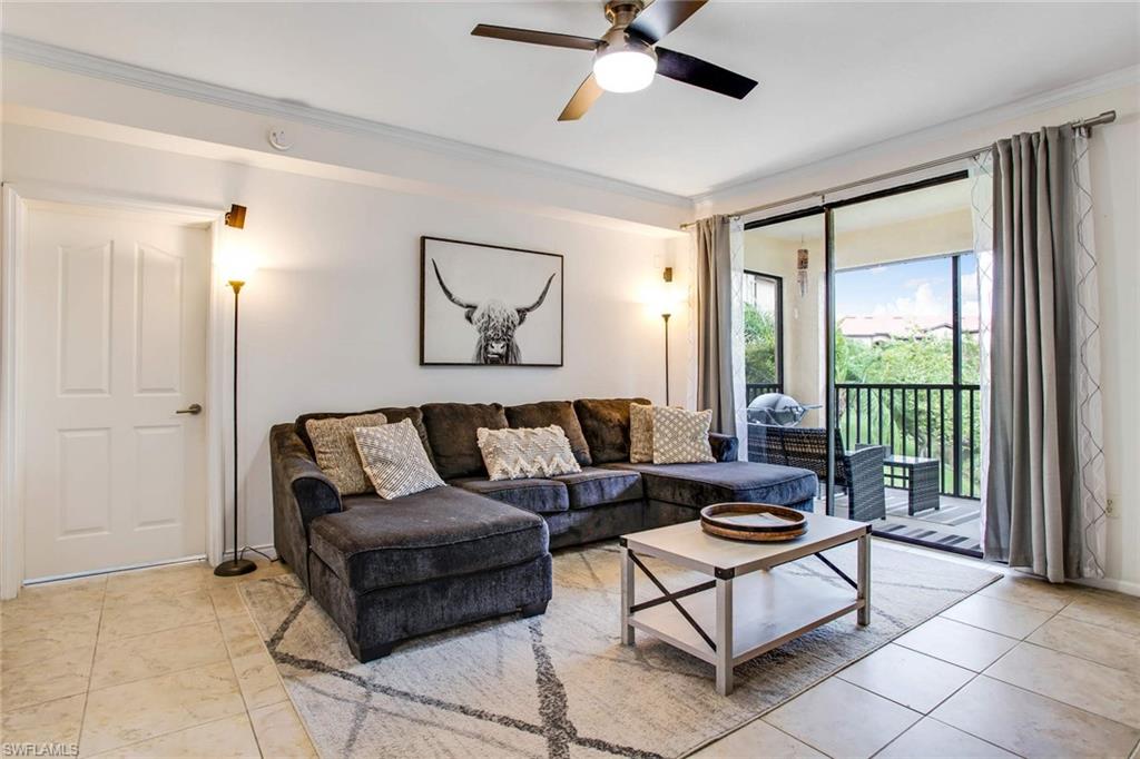 12980 Positano Circle, Unit 202 Naples, FL 34105 - Photo 4 of 27 a living room with furniture and a large window