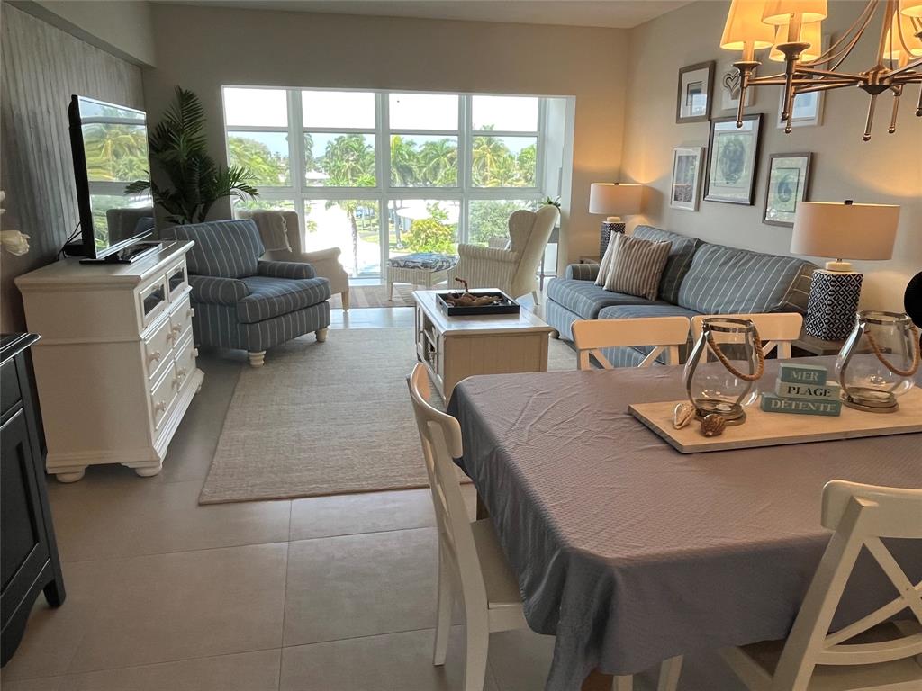 1481 South Ocean Boulevard, Unit 415A Pompano Beach, FL 33062 - Photo 1 of 39 a living room with furniture and a flat screen tv