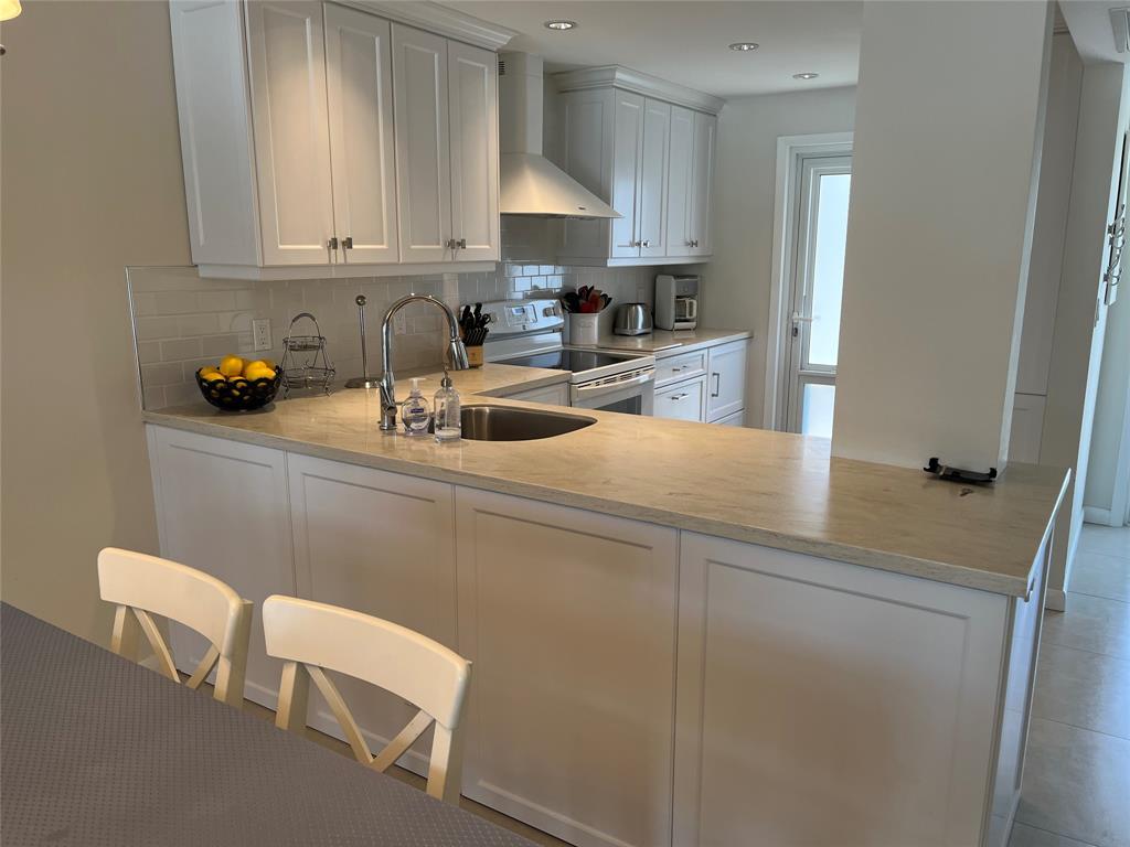 1481 South Ocean Boulevard, Unit 415A Pompano Beach, FL 33062 - Photo 12 of 39 a kitchen with a sink cabinets and window
