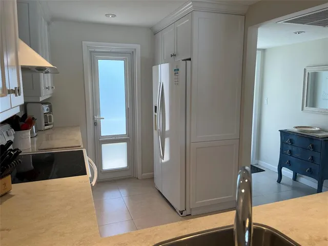 a view of a kitchen from the hallway