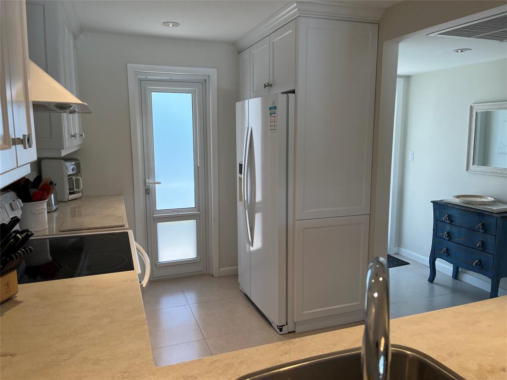 1481 South Ocean Boulevard, Unit 415A Pompano Beach, FL 33062 - Photo 14 of 39 a view of a kitchen from the hallway