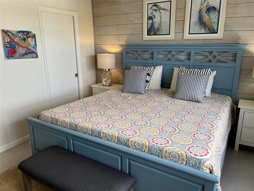 1481 South Ocean Boulevard, Unit 415A Pompano Beach, FL 33062 - Photo 15 of 39 a bedroom with a bed and cupboard