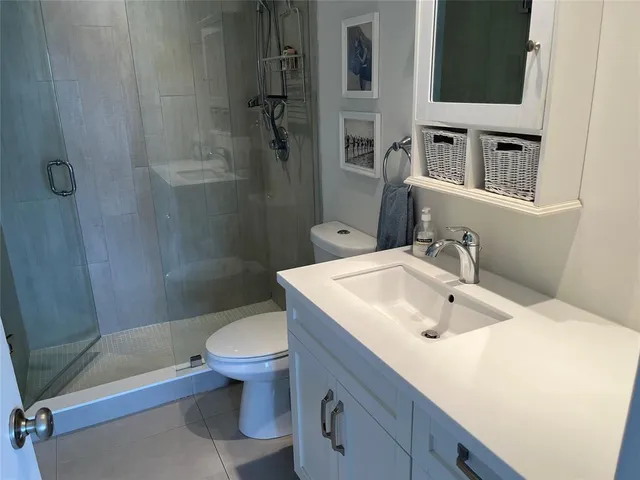 a bathroom with a sink toilet and shower