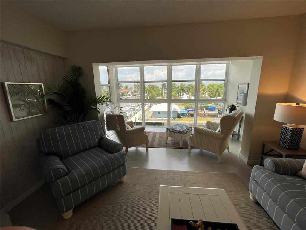 1481 South Ocean Boulevard, Unit 415A Pompano Beach, FL 33062 - Photo 2 of 39 a living room with furniture and a large window