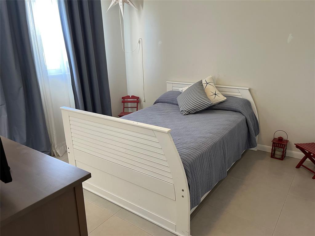 1481 South Ocean Boulevard, Unit 415A Pompano Beach, FL 33062 - Photo 22 of 39 a bedroom with a bed and a window