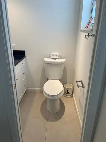 a white toilet sitting next to a white sink