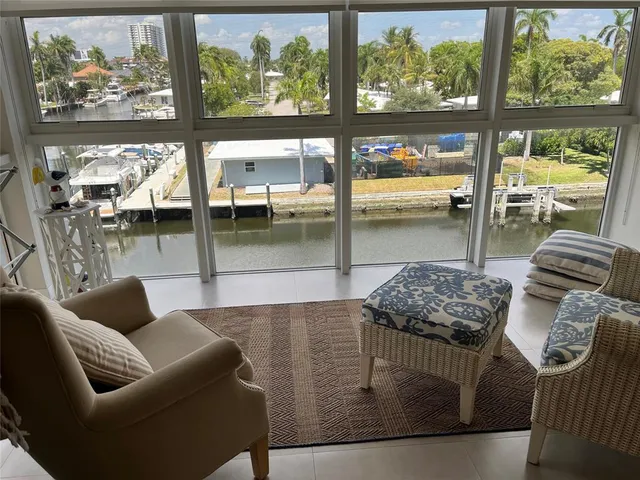 a living room with furniture and a floor to ceiling window