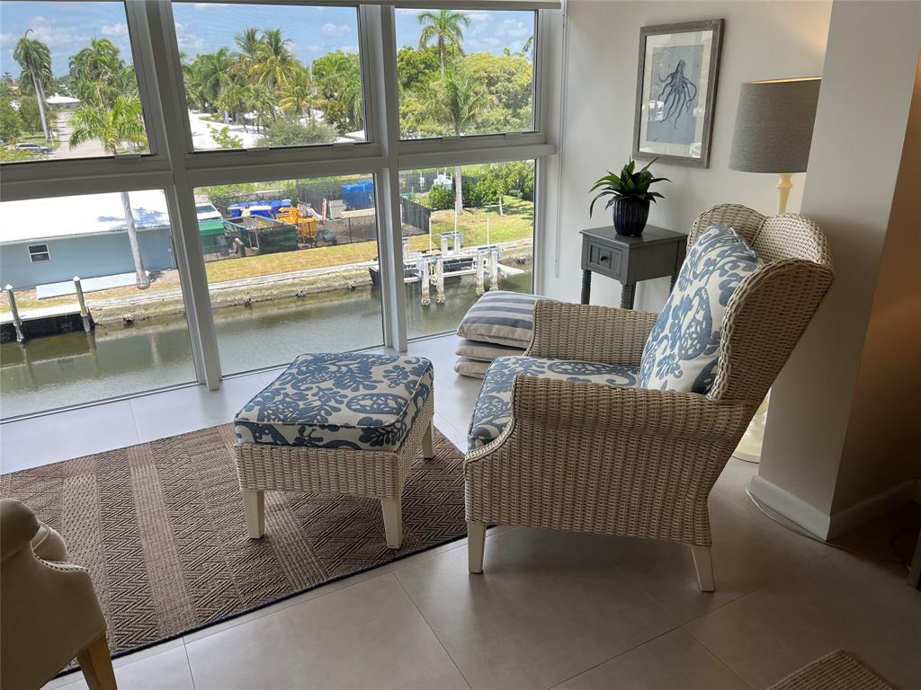 1481 South Ocean Boulevard, Unit 415A Pompano Beach, FL 33062 - Photo 28 of 39 a living room with furniture and a floor to ceiling window