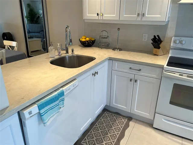 a kitchen with a sink and cabinets