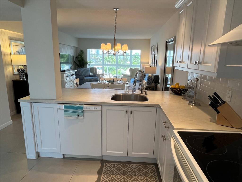 1481 South Ocean Boulevard, Unit 415A Pompano Beach, FL 33062 - Photo 32 of 39 a kitchen with a sink stove and cabinets