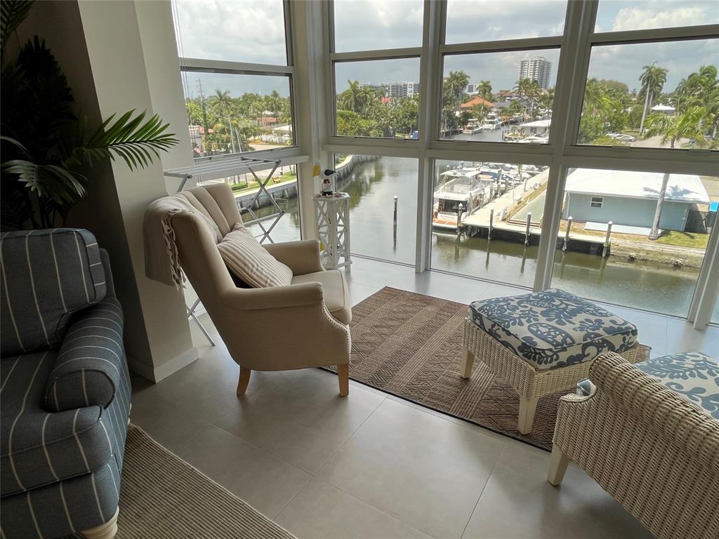 1481 South Ocean Boulevard, Unit 415A Pompano Beach, FL 33062 - Photo 4 of 39 a living room with furniture and a floor to ceiling window
