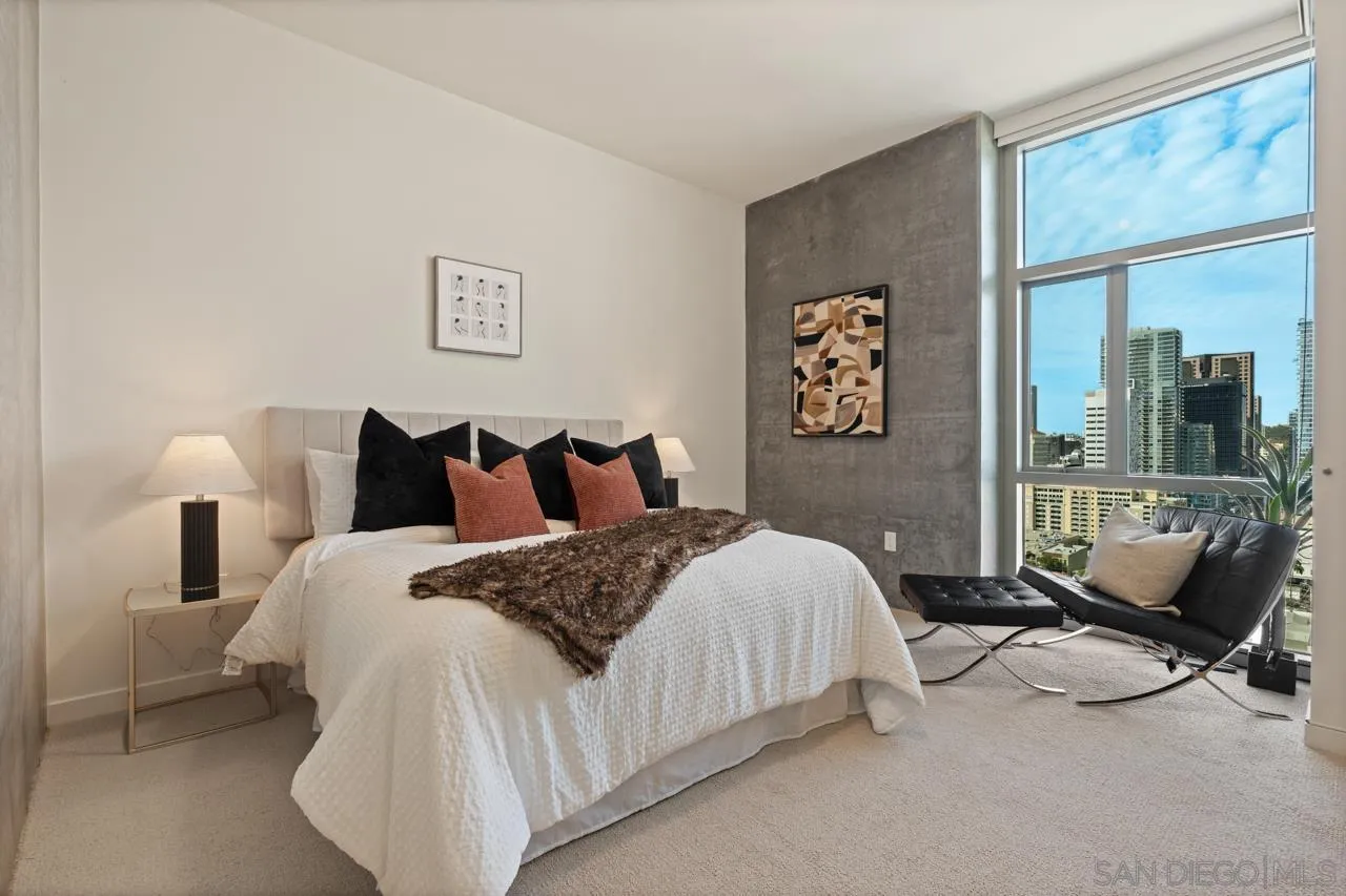 800 The Mark Lane, Unit 2103 San Diego, CA 92101 - Photo 2 of 25 a spacious bedroom with a bed and glass door