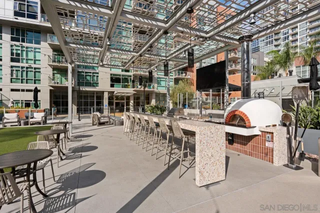 a view of a patio with couches table and chairs with potted plants