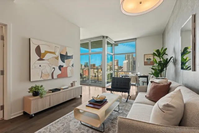 a living room with furniture and wooden floor