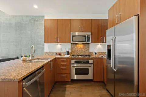 a kitchen with a sink stove and refrigerator