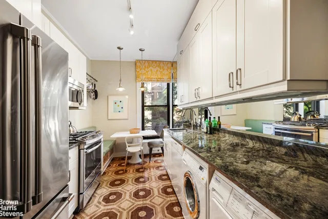 a kitchen with stainless steel appliances granite countertop a refrigerator and stove