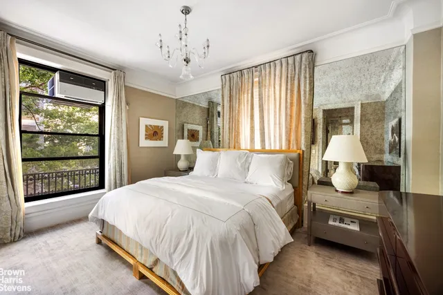 a spacious bedroom with a large bed and a window