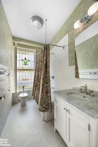 a spacious bathroom with a granite countertop sink a toilet and a mirror