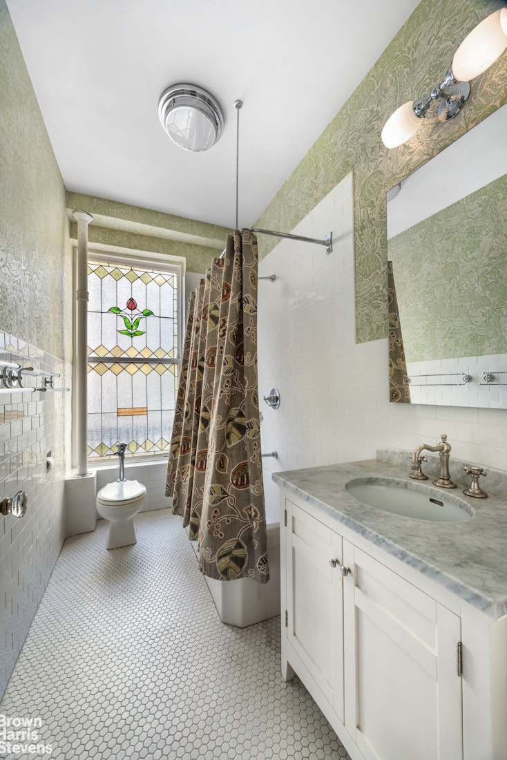 645 West End Avenue, Unit 2A Manhattan, NY 10025 - Photo 9 of 13 a spacious bathroom with a granite countertop sink a toilet and a mirror