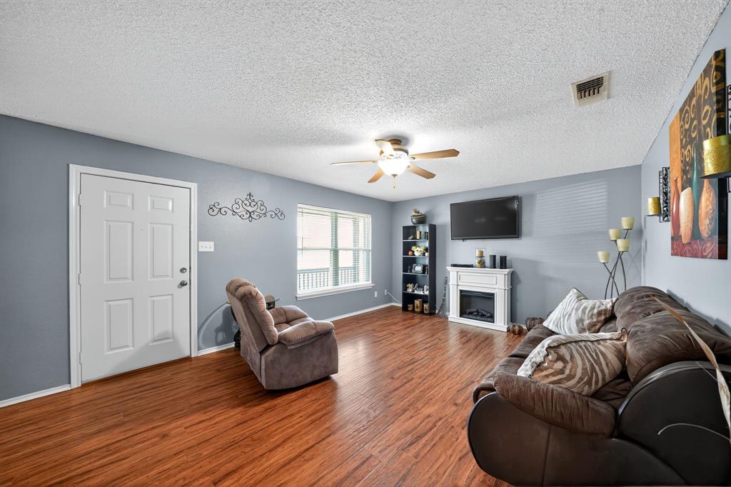 604 McAnear Street Cleburne, TX 76033 - Photo 11 of 18 a living room with furniture and a fireplace