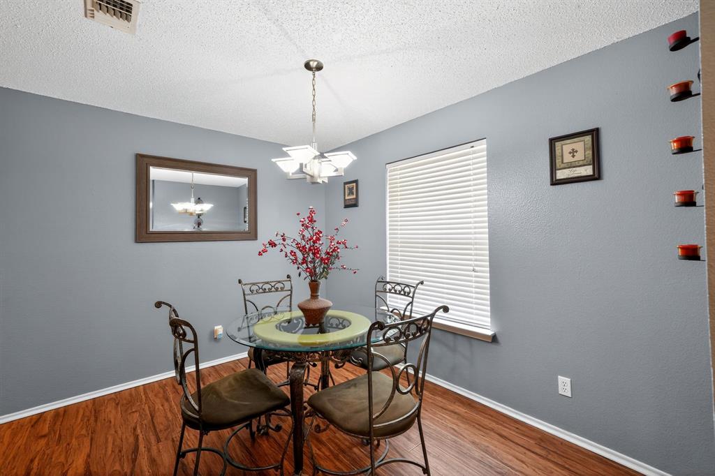604 McAnear Street Cleburne, TX 76033 - Photo 9 of 18 a view of a dining room with furniture and chandelier