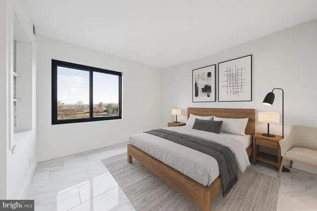 a bedroom with a bed and a window