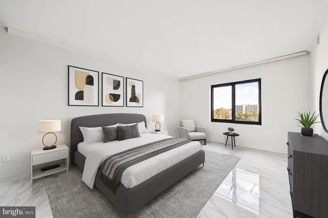 a bedroom with a large bed and a window