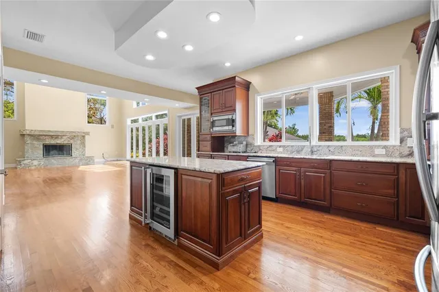 wooden floor fireplace and windows in an empty room