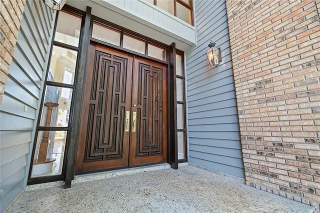a view of an empty room with floor to ceiling windows and a kitchen