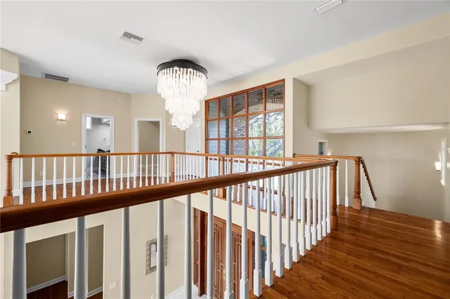 a view of a hallway with wooden floor and entryway