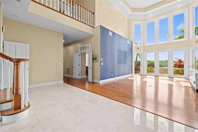 a view of a hallway with wooden floor and stairs