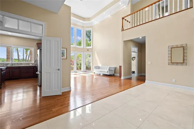 a large kitchen with stainless steel appliances a large counter top a stove and a wooden floors