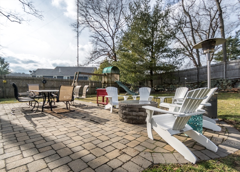 27 Sherman Street Needham, MA 02494 - Photo 28 of 32 a view of a patio with a dining table and chairs with wooden fence