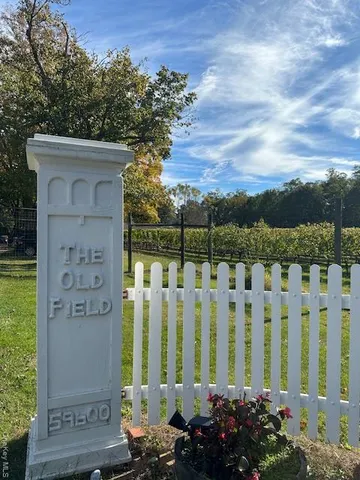 a view of a yard with wooden fence