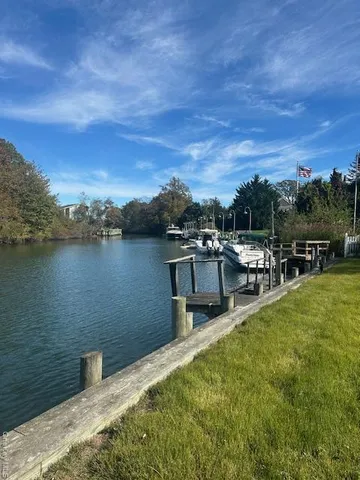 a view of a lake with houses in the back