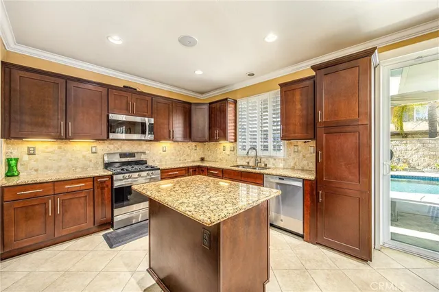 a kitchen with a stove sink and refrigerator
